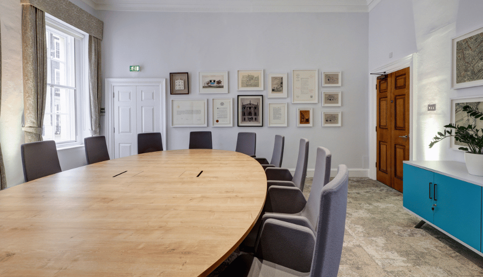 Image of the Folkestone Room with the furniture arranged in boardroom style.