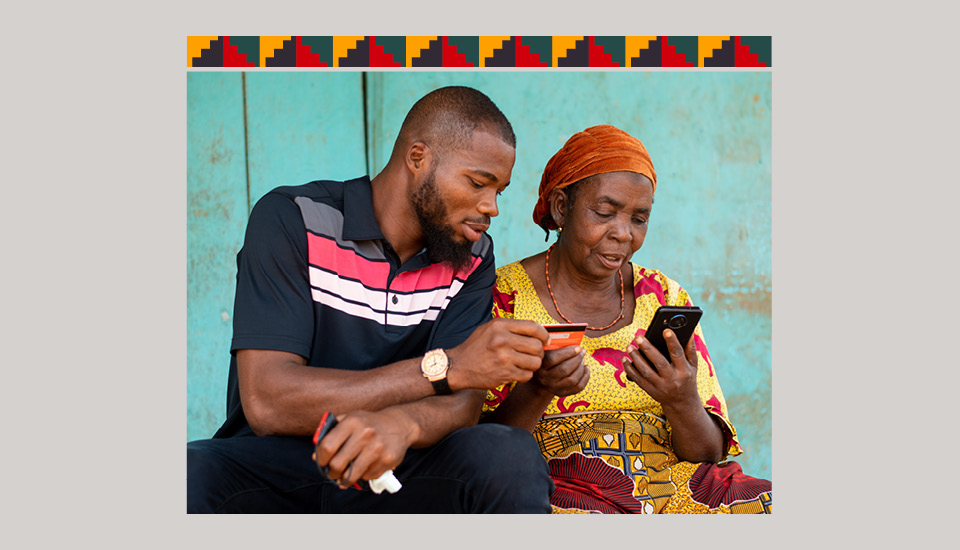 Someone helps another person to bank on their mobile phone.