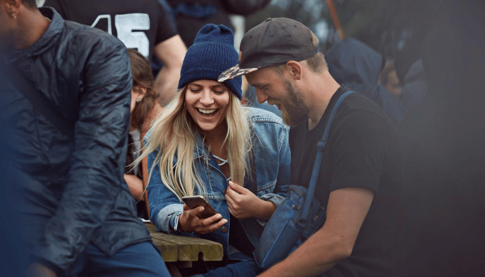 festival goers looking at their mobile devices